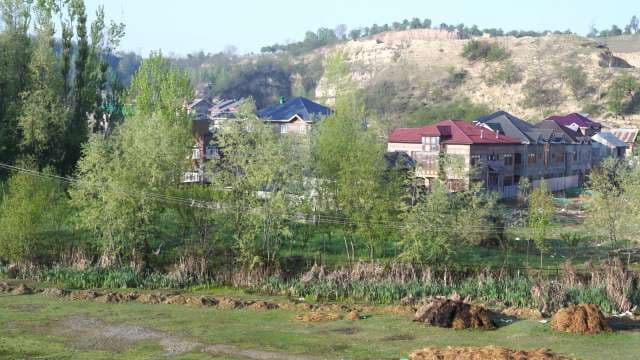 Scenic Rural Houses Nestled in Green Valley Near Hillside
