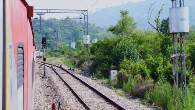 Scenic Train Journey Through Lush Green Hills in India
