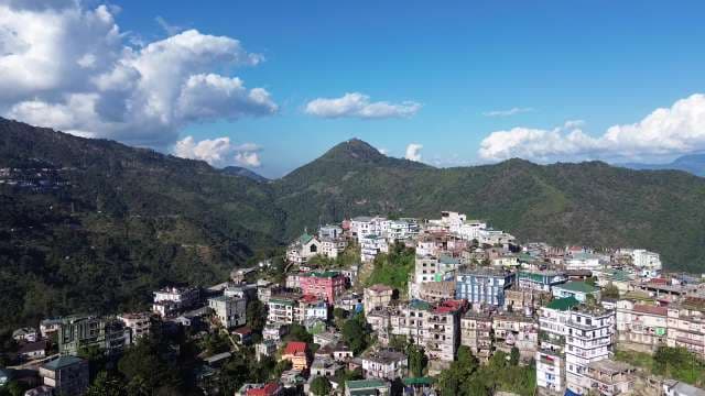 Aerial View of Vibrant Mountain City with Colorful Buildings and Hills