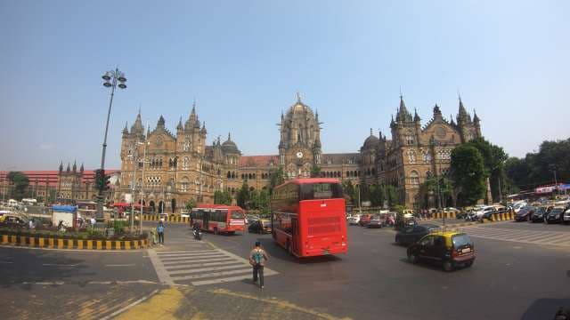 Chhatrapati Shivaji Maharaj Terminus and Red Bus in Mumbai