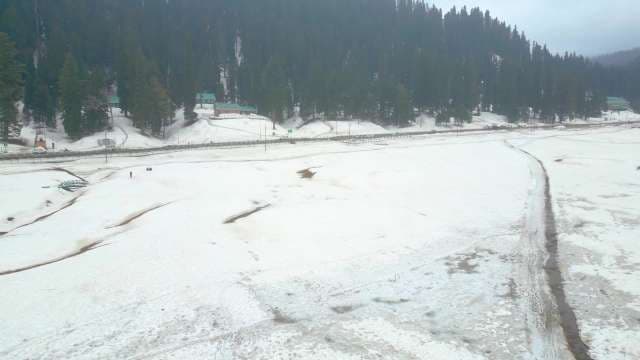 Aerial View of Snowy Gulmarg Landscape and Pine Forest