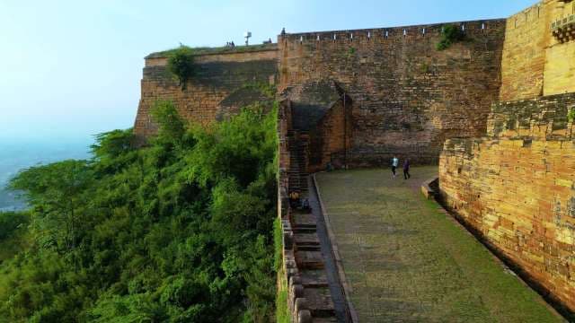 Ancient Gwalior Fort Sandstone Walls and Hillside Greenery in India