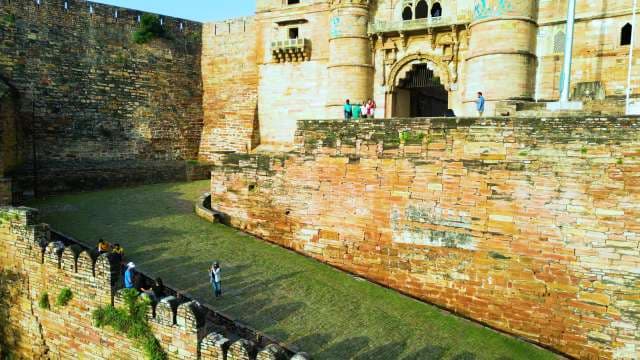 Tourists Exploring Ancient Gwalior Fort Architecture in India