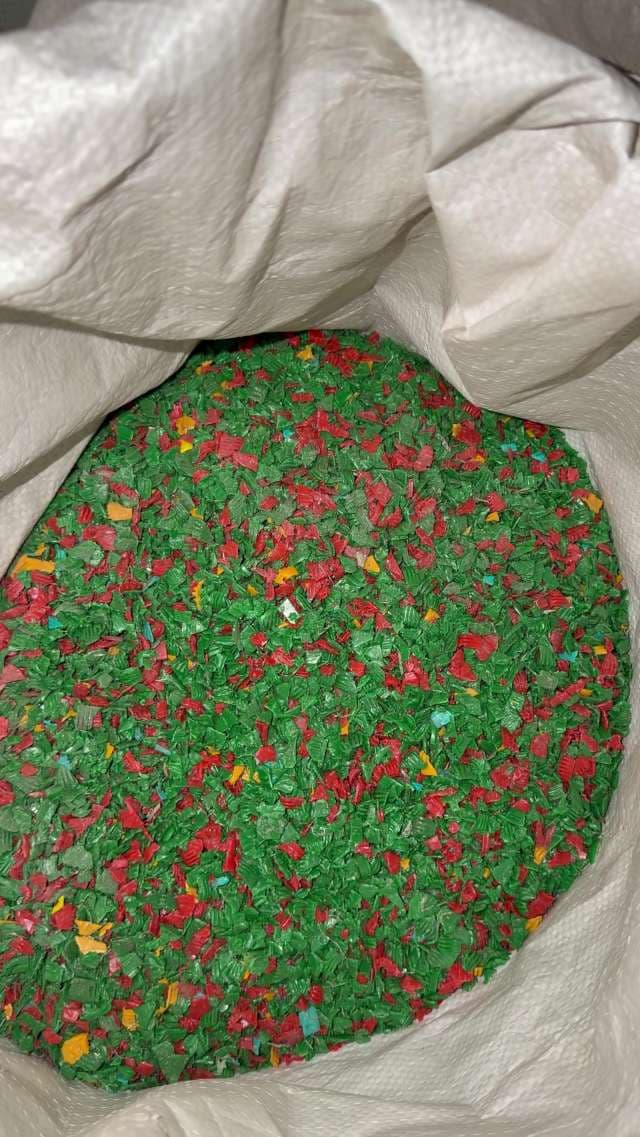 Green and Red Recycled Plastic Flakes in Industrial Bag