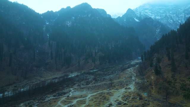 Aerial View of Misty Himalayan Mountain Valley and Rugged Trails at Manali