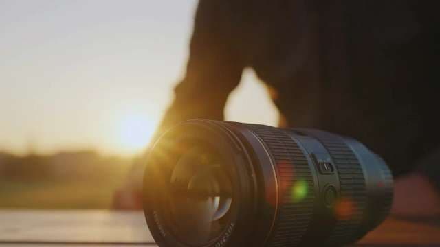 Close-up of Professional Camera Lens at Sunset Golden Hour