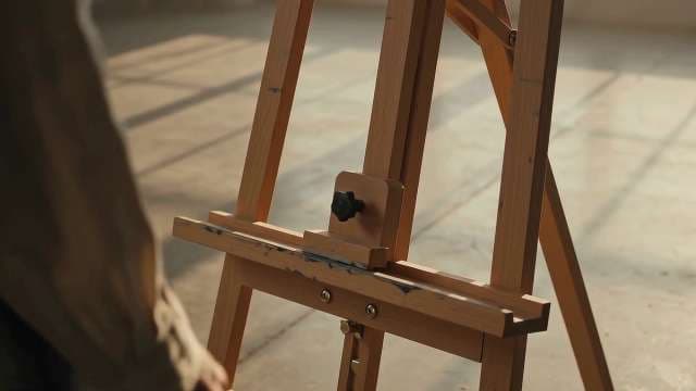 Wooden Easel in Sunlit Art Studio Workspace