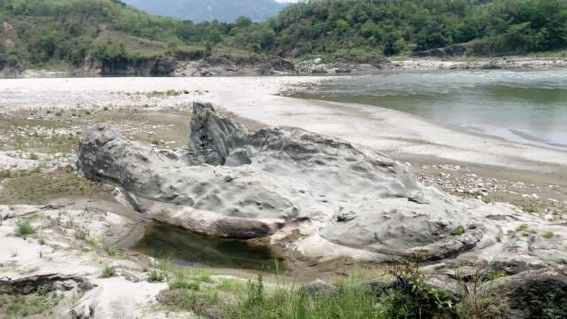Scenic Rocky Riverbank and Lush Hills Near Flowing Water in Himachal