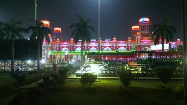 Illuminated Lucknow Charbagh Railway Station with Vintage Steam Engine at Night