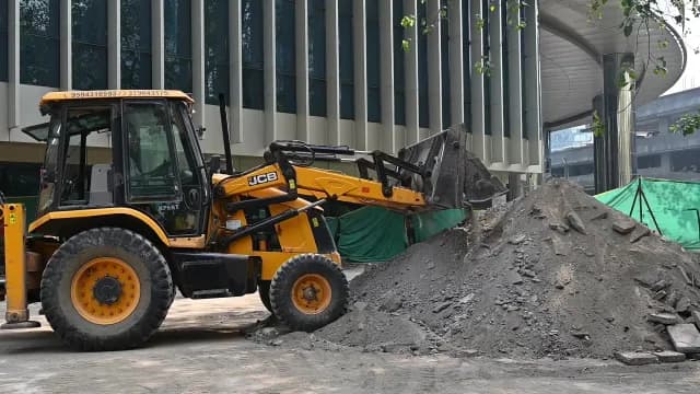 Yellow JCB Backhoe Loader at Urban Construction Site