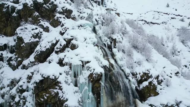 Aerial View of Frozen Waterfall and Snowy Mountain Cliff in Srinagar