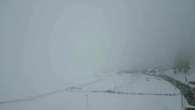 Atmospheric Fog Over Snowy Mountain Resort in Srinagar