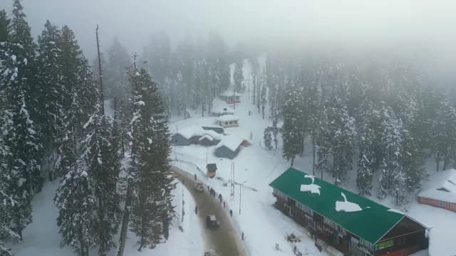 Aerial View of Foggy Snow-Covered Village in the Mountains