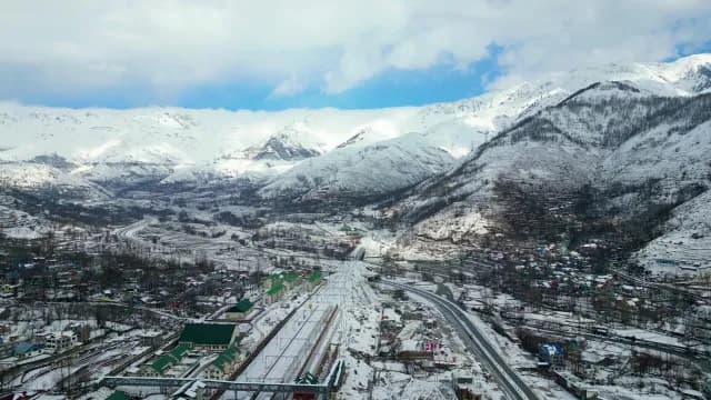 Aerial View of Snowy Srinagar Valley and Railway Infrastructure