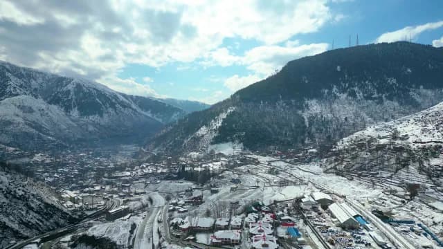 Aerial View of Snow-Covered Himalayan Village in Srinagar Valley