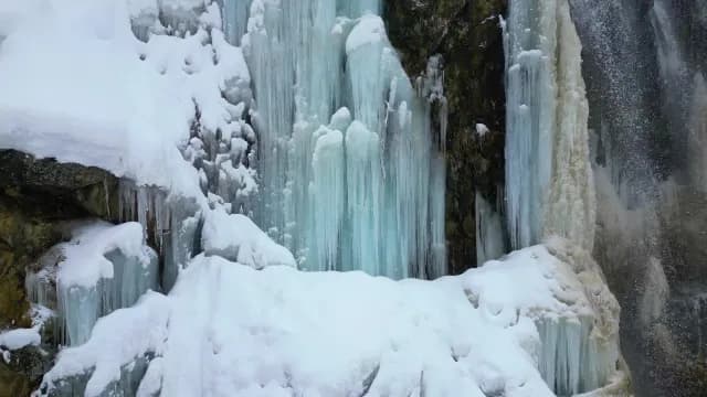 Close-up of Frozen Waterfall with Turquoise Ice and Deep Snow, Srinagar