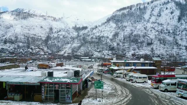 Snowy Srinagar Town Scene with Local Shops and Transport
