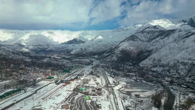 Aerial Panorama of Snowy Mountain Town and Railway Station