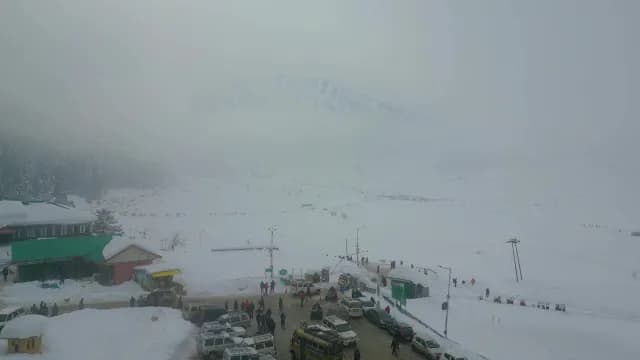Aerial View of Misty Kashmir Mountain Resort and Snowy Winter Landscape