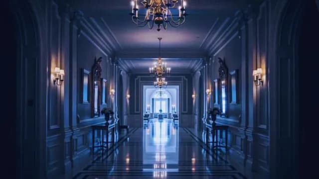 Elegant Symmetrical Palace Hallway with Chandeliers and Blue Ambient Lighting