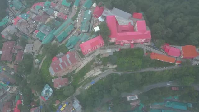 Aerial View of Misty Shimla Cityscape with Red Roofed Buildings