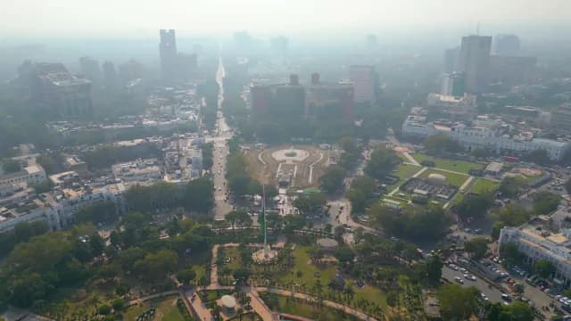 Aerial View of Smoggy New Delhi Cityscape and Indian Flag