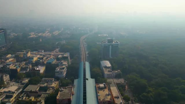 Aerial View of Metro Tracks in Smoggy Delhi Cityscape