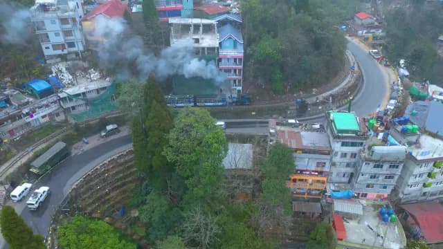 Darjeeling Toy Train Steaming Through Hillside Town