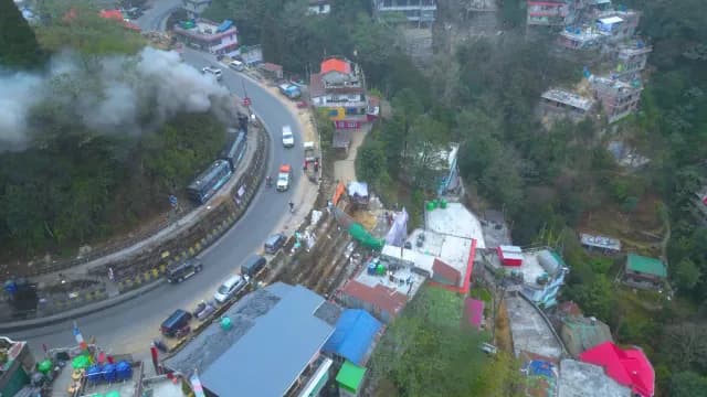 Darjeeling Himalayan Railway Steam Train Traveling Through Mountain Town