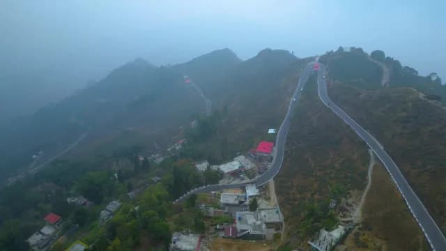 Aerial View of Winding Mountain Road Through Foggy Himalayan Hills in Darjeeling