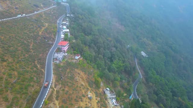 Aerial View of Winding Mountain Highway Through Lush Tea Gardens - Darjeeling