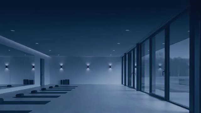 Modern Empty Yoga Studio with Night Lighting and Large Windows