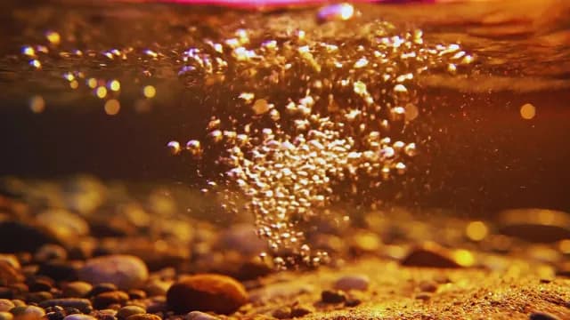 Underwater Golden Bubbles Rising Above Pebbled Riverbed in Warm Light