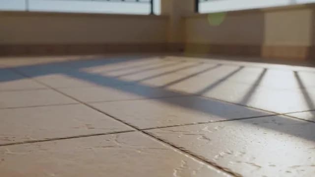Sunlight Railing Shadows on Modern Tiled Balcony Floor