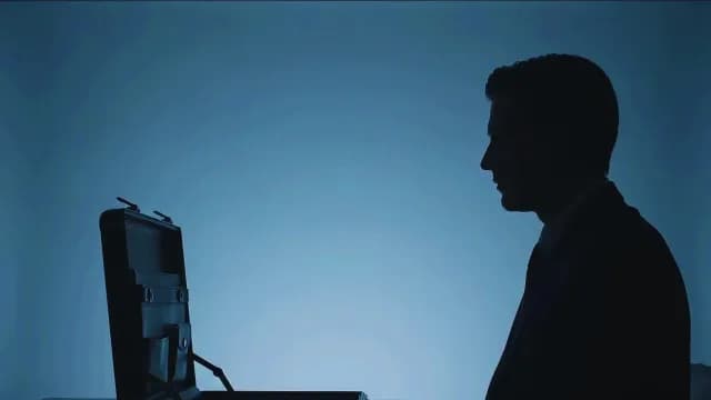 Silhouette of Businessman Looking into Open Briefcase