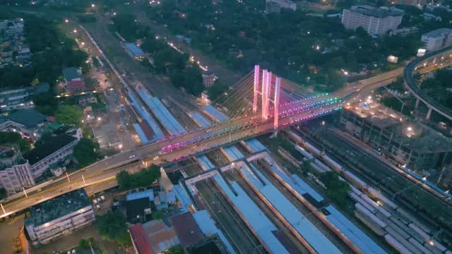 Aerial Night View of Illuminated Cable Stayed Bridge Over Railway Station