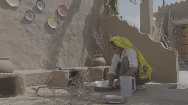 Traditional Indian Woman Cooking on Outdoor Clay Stove in Rural Village