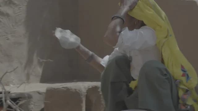 Traditional Rajasthani Woman Preparing Roti Flatbread in Rural Kitchen
