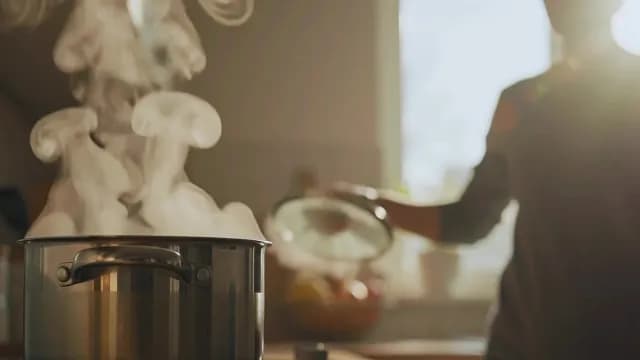 Dramatic Steam Rising from Boiling Pot in Sunny Kitchen