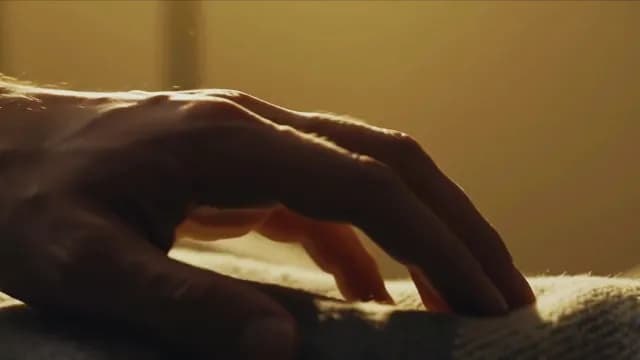 Cinematic Close-up of Hand on Soft Fabric in Golden Light