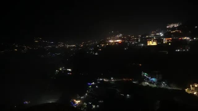 Nighttime Aerial View of Glowing Mussoorie Hill Station Cityscape