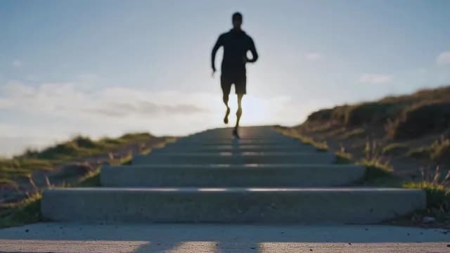 Silhouette of Athlete Running Down Stairs at Sunrise