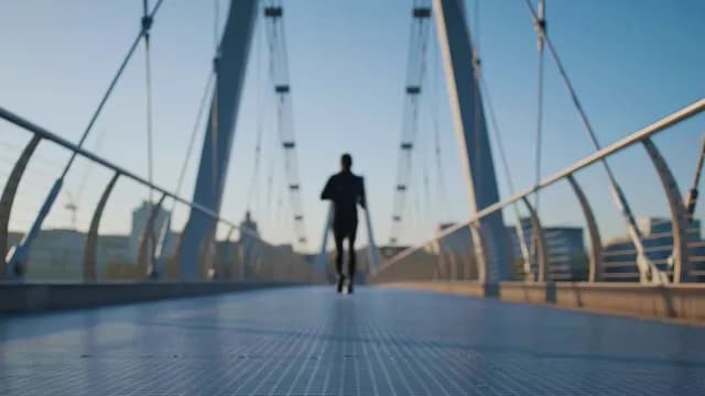 Runner Jogging Across Modern City Bridge at Sunrise