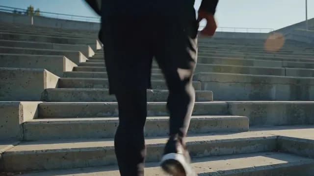 Male Athlete Sprinting Up Concrete Stairs During Outdoor Workout