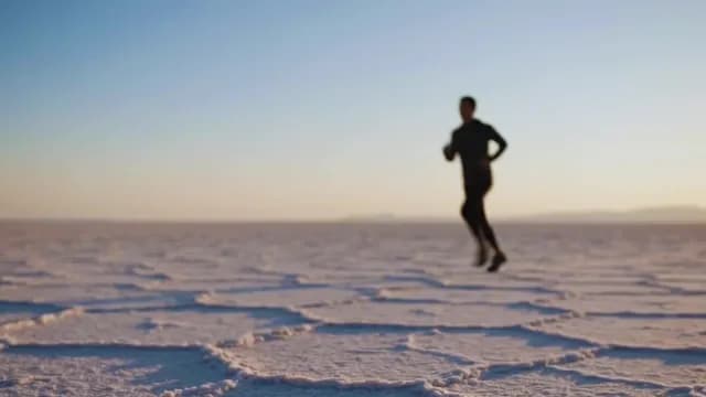 Male Athlete Jogging on Salt Flat at Sunrise