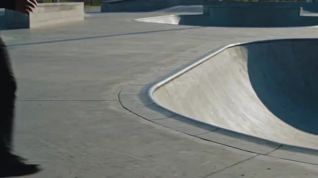 Modern Concrete Skatepark Bowl Under Bright Sunlight