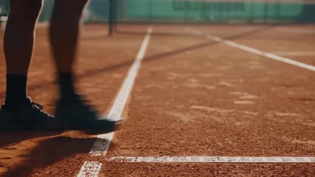 Close Up of Tennis Player Standing on Red Clay Court