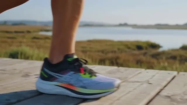Close-Up of Athlete Jogging on Scenic Outdoor Boardwalk