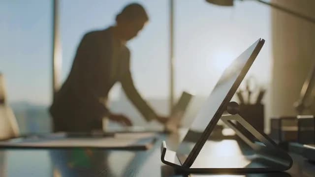 Businesswoman Working in Modern High-Rise Office During Golden Hour
