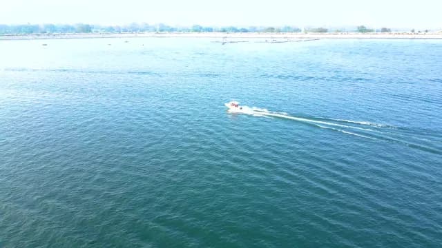 Speedboat Cruising Across Vast Blue Patratu Lake